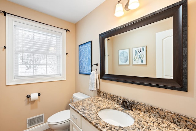 bathroom featuring vanity and toilet