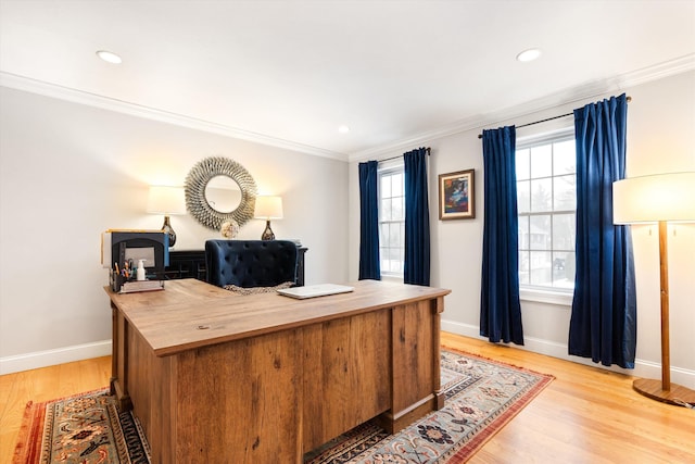 home office with crown molding and light hardwood / wood-style flooring