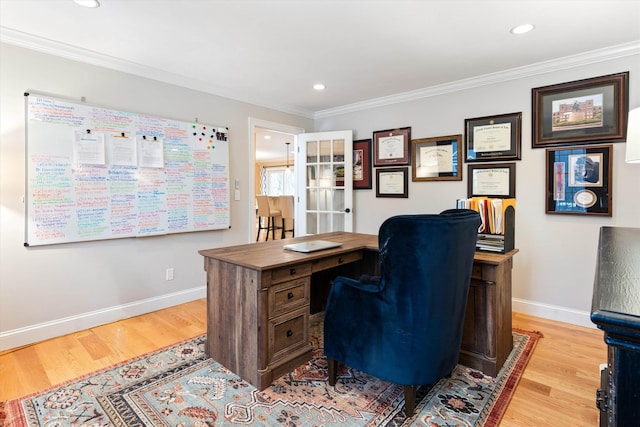 office with ornamental molding and light hardwood / wood-style floors