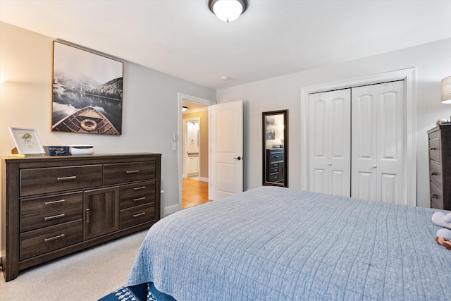 bedroom with light carpet and a closet