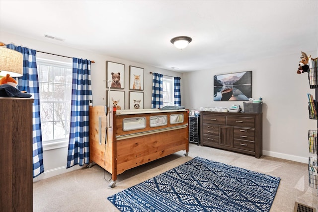 bedroom featuring light colored carpet