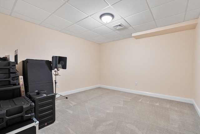 workout area with light colored carpet and a drop ceiling