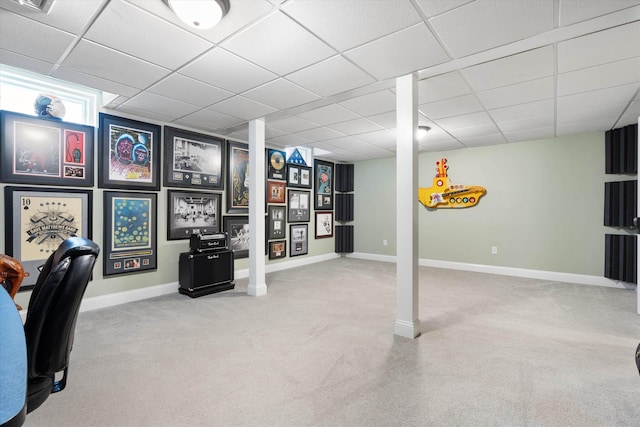 carpeted office with a paneled ceiling