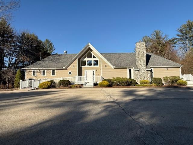 359 Winding Pond Rd Unit 359, Londonderry, NH 03053 - view of front of property featuring fence and a chimney
