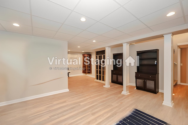 359 Winding Pond Rd Unit 359, Londonderry, NH 03053 - unfurnished living room with baseboards, a drop ceiling, and wood finished floors