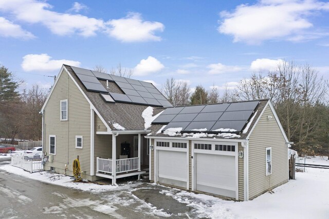 view of front of property featuring solar panels and a porch