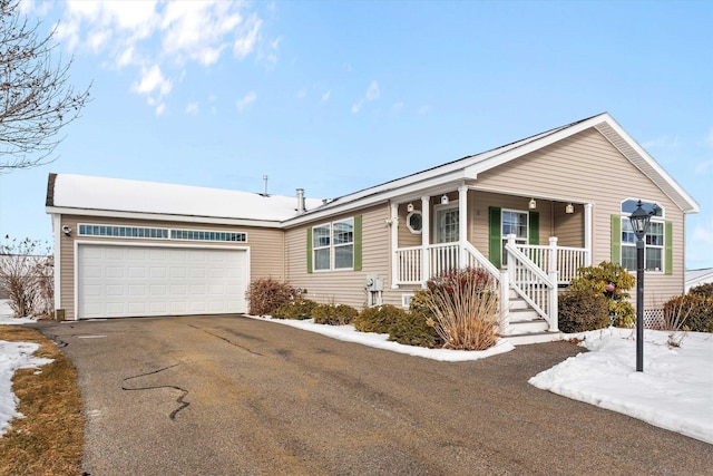 single story home with a garage and covered porch