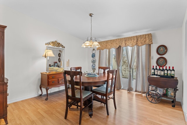 dining room featuring a chandelier and light wood-type flooring