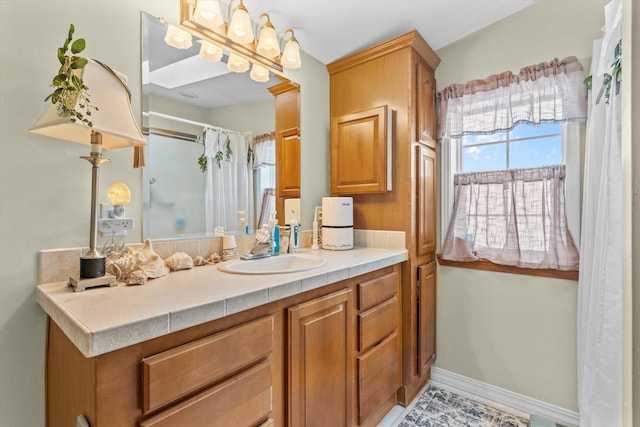 bathroom featuring vanity and curtained shower