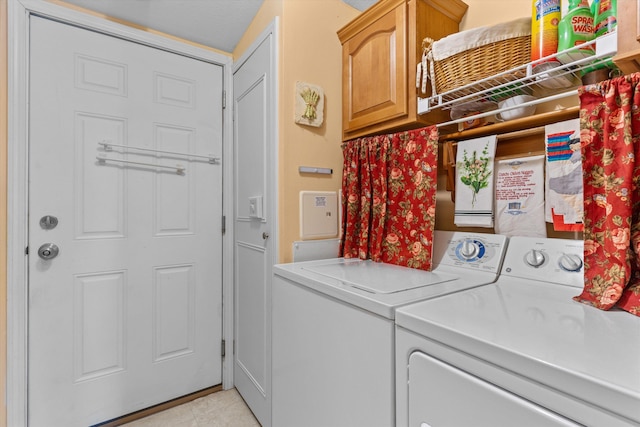 laundry area featuring cabinets and separate washer and dryer