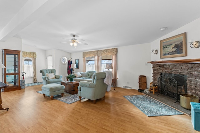 living room with vaulted ceiling, ceiling fan, and light hardwood / wood-style floors