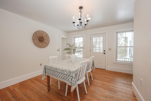 dining space featuring a notable chandelier and light hardwood / wood-style flooring