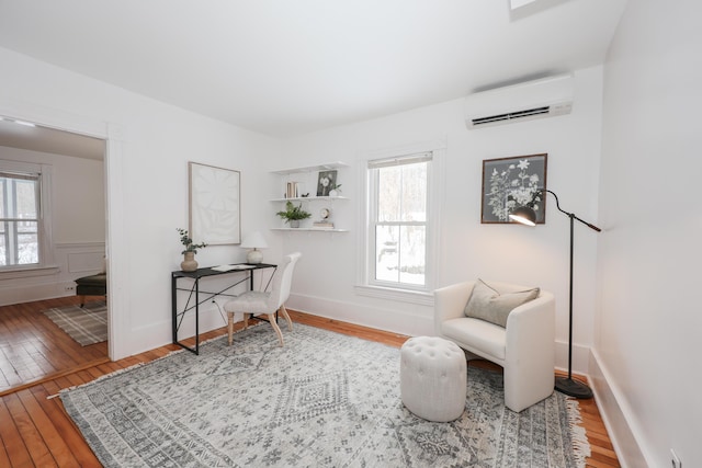 office featuring a wall mounted AC and hardwood / wood-style floors