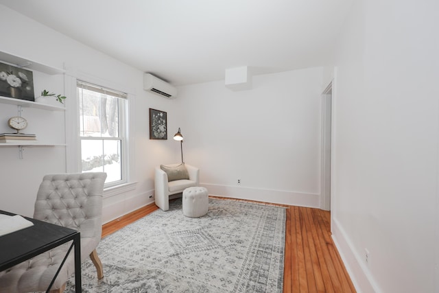 office featuring wood-type flooring and a wall mounted AC