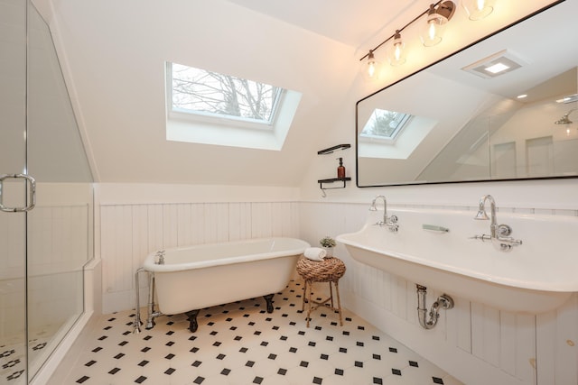 bathroom with lofted ceiling with skylight and plus walk in shower