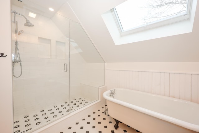 bathroom with lofted ceiling with skylight and plus walk in shower