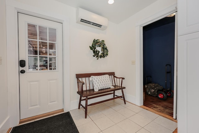 doorway to outside with a wall mounted air conditioner and light tile patterned floors