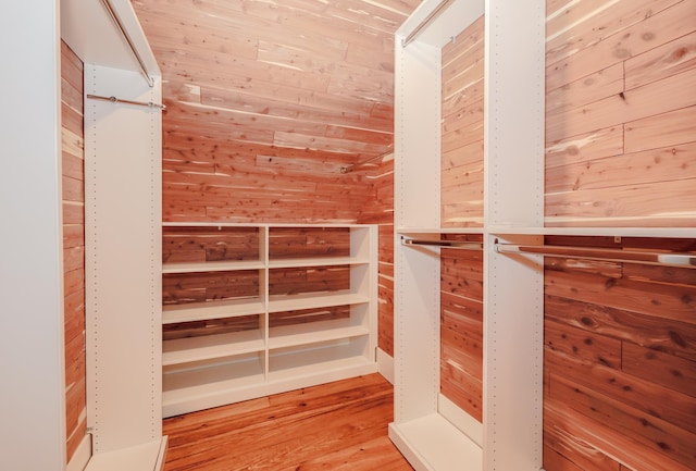 walk in closet with wood-type flooring