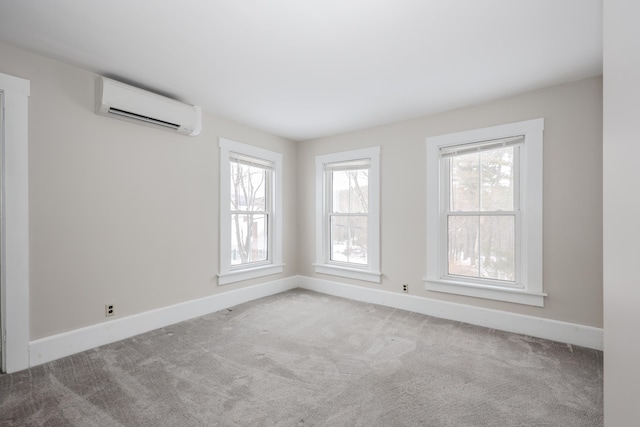 unfurnished room featuring light carpet, plenty of natural light, and a wall unit AC