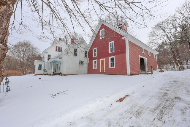 view of snow covered back of property