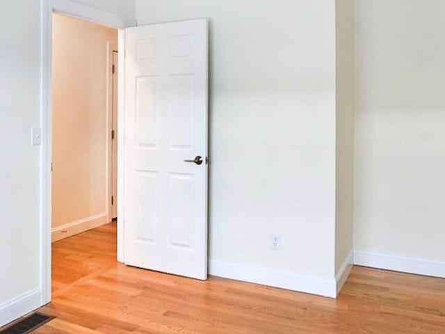 unfurnished room with light wood-type flooring