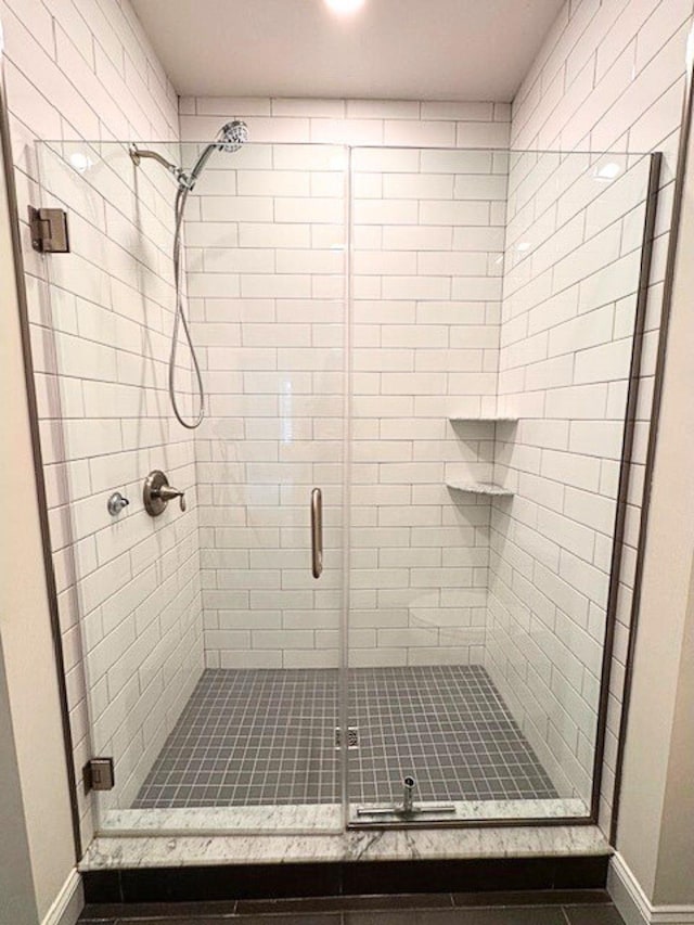 bathroom with a shower with door