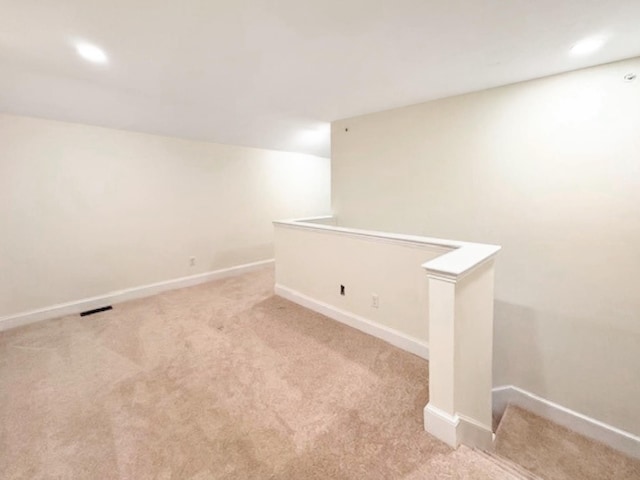 basement featuring light colored carpet