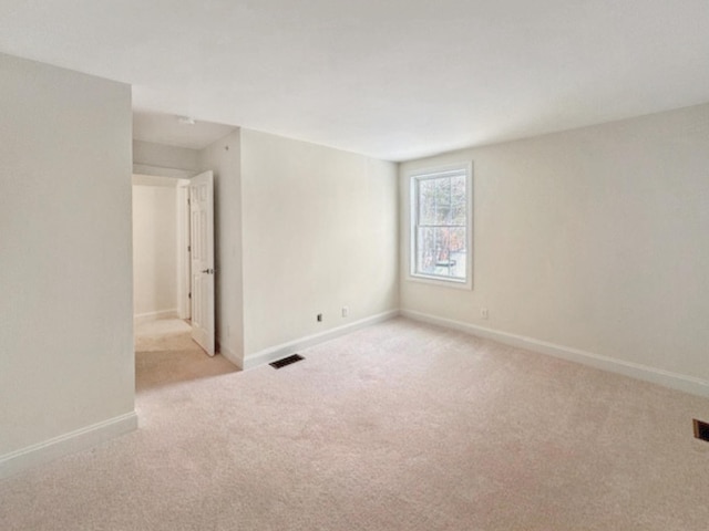 unfurnished room with light carpet