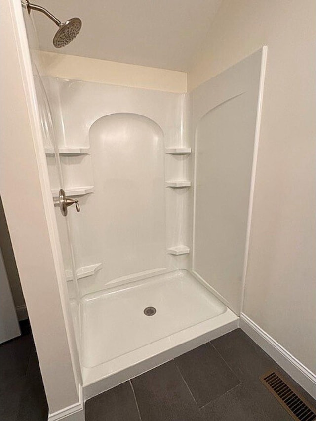 bathroom featuring walk in shower and tile patterned floors