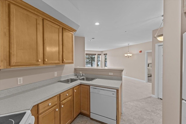 kitchen with decorative light fixtures, sink, light colored carpet, kitchen peninsula, and white appliances