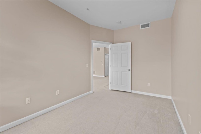 spare room with light colored carpet