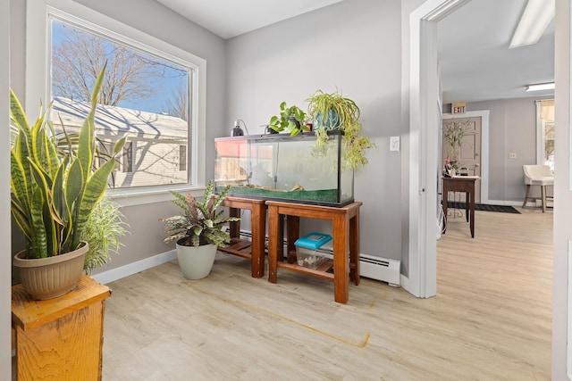 interior space with light hardwood / wood-style flooring and baseboard heating