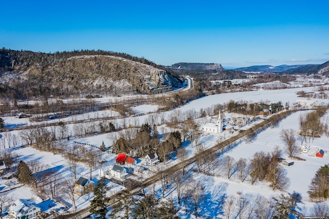 snowy aerial view with a mountain view