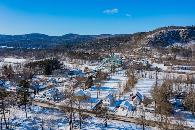 snowy aerial view with a mountain view