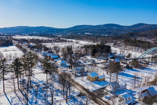 snowy aerial view featuring a mountain view