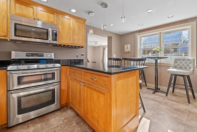 kitchen featuring stainless steel appliances, pendant lighting, a kitchen breakfast bar, and kitchen peninsula