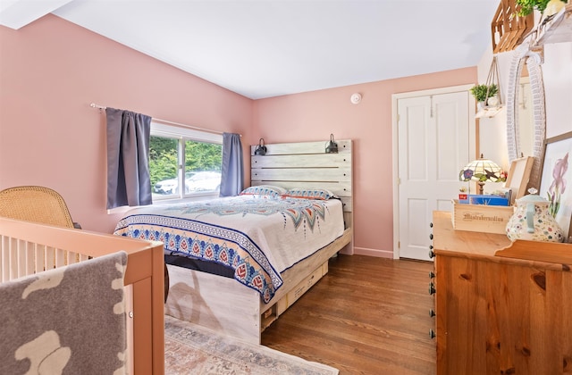 bedroom featuring dark wood finished floors and baseboards