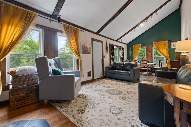 living area with high vaulted ceiling, plenty of natural light, beamed ceiling, and light wood finished floors