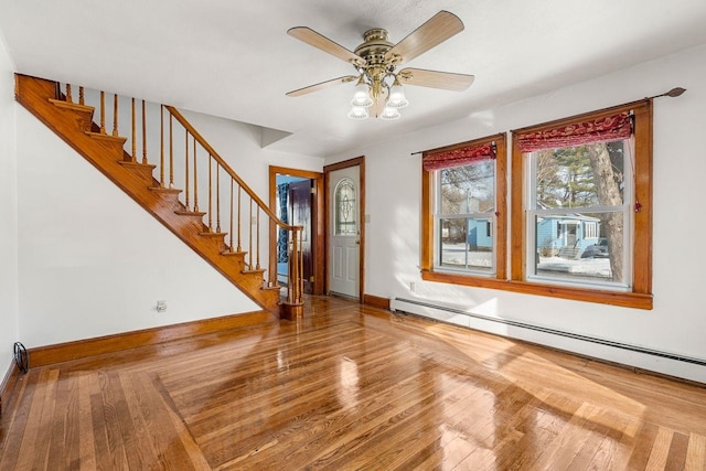 entrance foyer featuring baseboard heating, ceiling fan, and hardwood / wood-style floors