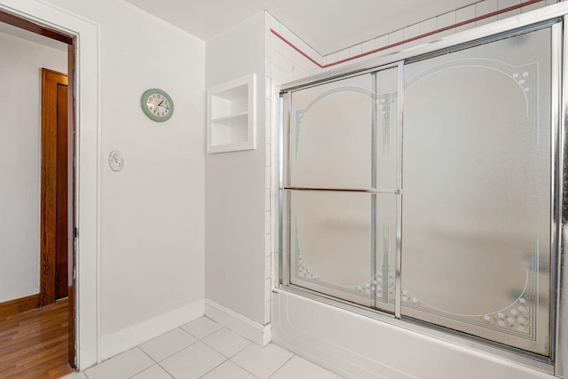 bathroom featuring tile patterned floors and combined bath / shower with glass door