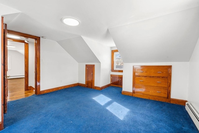 bonus room featuring dark colored carpet, lofted ceiling, and a baseboard heating unit