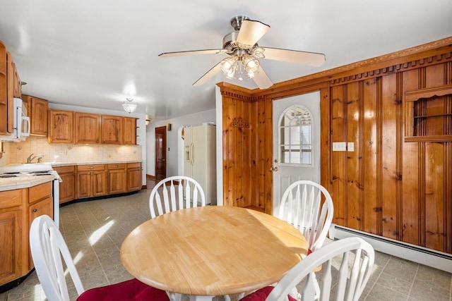 dining area featuring a baseboard radiator and ceiling fan