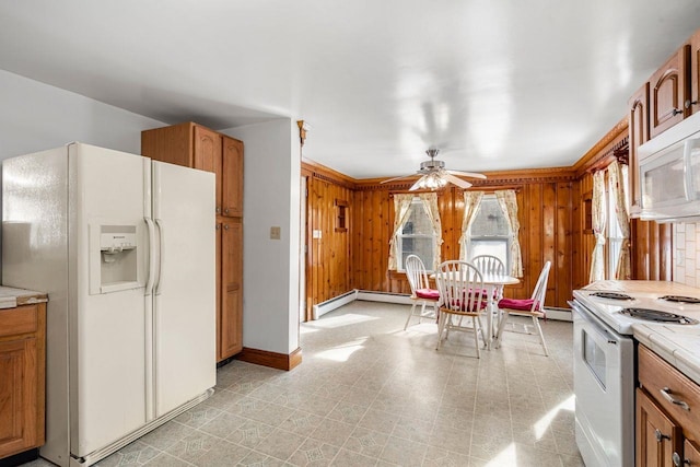 kitchen with tile counters, white appliances, wooden walls, and ceiling fan