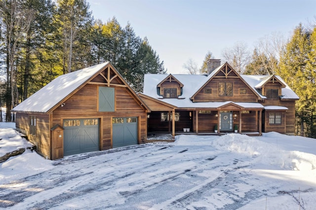 log-style house with a garage