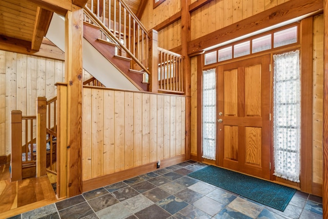 entrance foyer featuring wooden walls