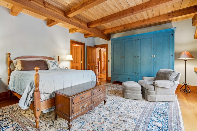 bedroom with wooden ceiling, beam ceiling, and light hardwood / wood-style flooring