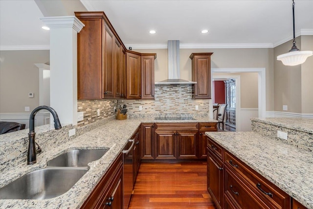 kitchen featuring wall chimney range hood, sink, hanging light fixtures, dark hardwood / wood-style floors, and black electric cooktop