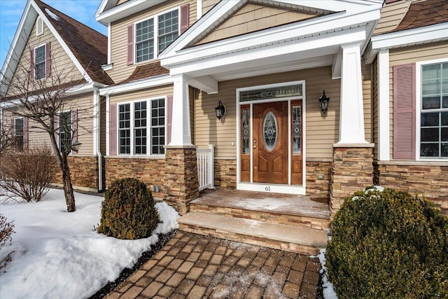 view of snow covered property entrance