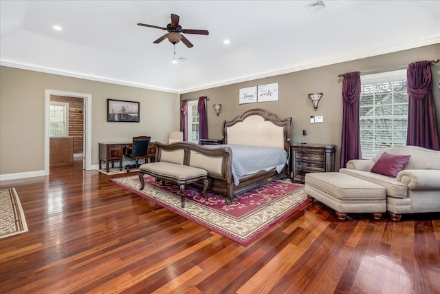 bedroom with crown molding, ceiling fan, and dark hardwood / wood-style floors