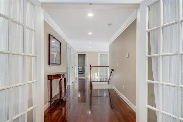 corridor with ornamental molding and dark hardwood / wood-style flooring